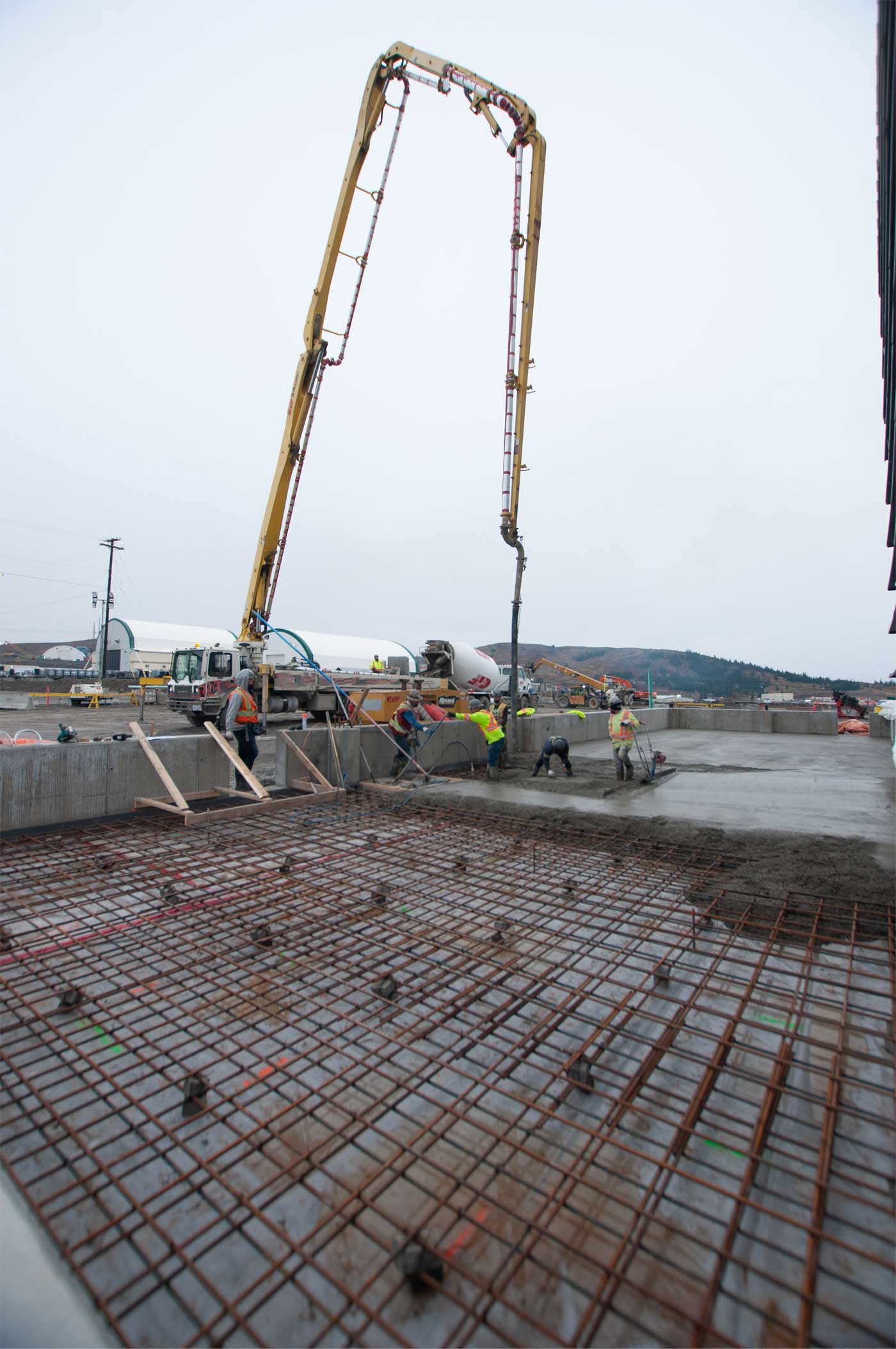 Concrete being poured with large machinery