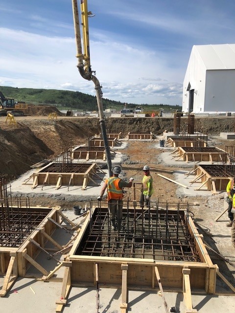 Workers on site while concrete is being poured